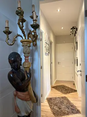 a statue of a child holding a bat in a hallway at Villa avec piscine in Alata