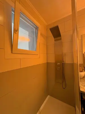 a bathroom with a shower and a window at Villa avec piscine in Alata