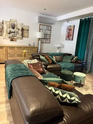 a living room with two couches and a couch at Villa avec piscine in Alata