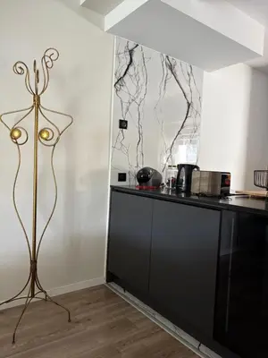 a kitchen with a black counter top and a table at Villa avec piscine in Alata
