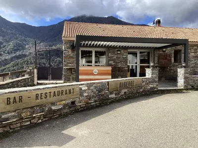 a bar restaurant with a sign in front of it at Auberge chez François in Ortale