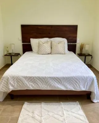 a bedroom with a large white bed with two tables at Auberge chez François in Ortale
