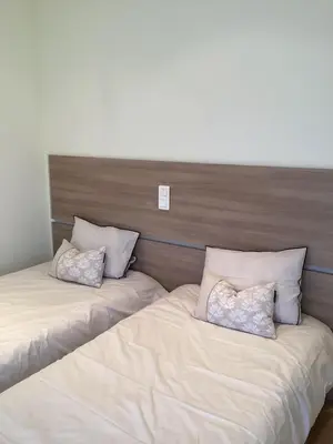 two beds sitting next to each other in a bedroom at Auberge chez François in Ortale