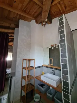 a bathroom with a sink and a mirror at Casa Ghjadda - gite ombragé avec accès piscine - in Appietto