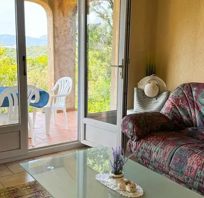 a living room with a couch and a glass table at Domaine Mare e Monti - T2 Les Mimosas in Albitreccia