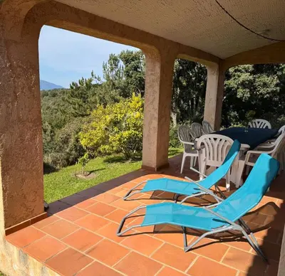 a patio with chairs and a table with a view at Domaine Mare e Monti - T2 Les Mimosas in Albitreccia