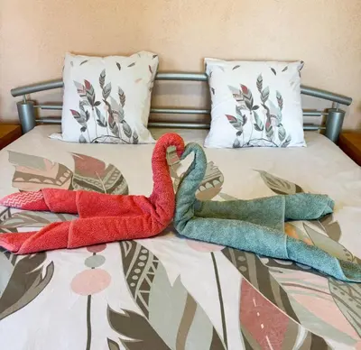 two swans sitting on top of a bed at Domaine Mare e Monti - T2 Les Mimosas in Albitreccia