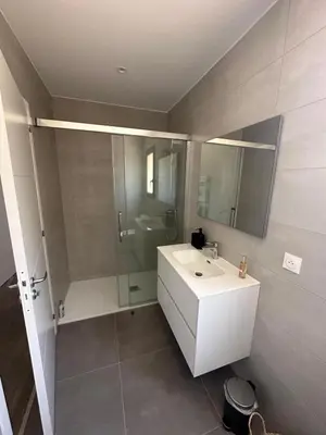 a bathroom with a white sink and a shower at Casa Juliette Maison bois in Aléria