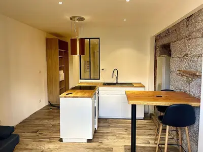 a kitchen with a sink and a wooden table at Lovely apartment in Sartène in Sartène