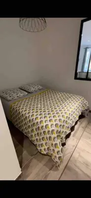 a bed sitting in a corner of a room at Lovely apartment in Sartène in Sartène