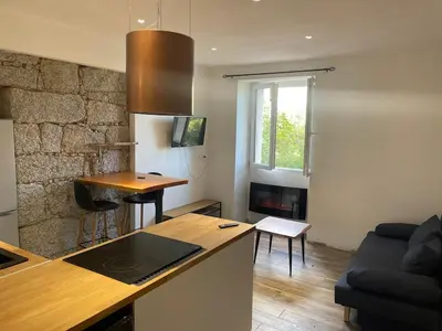 a kitchen and living room with a counter top at Lovely apartment in Sartène in Sartène