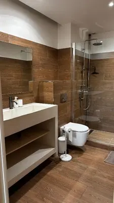 a bathroom with a sink and a toilet and a shower at Appartemment vue mer 50m2 in Propriano