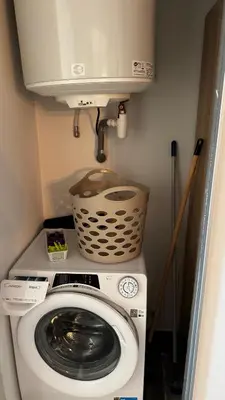 a washing machine with a tank on top of it at Appartemment vue mer 50m2 in Propriano