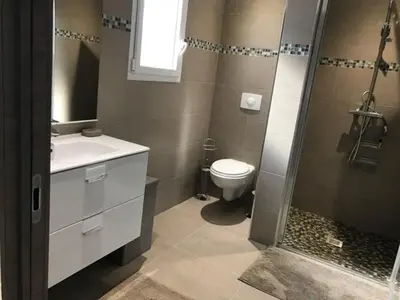 a bathroom with a toilet and a sink and a shower at PDM Appartement Paese di Mare in Santa-Lucia-di-Moriani
