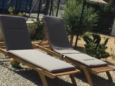 two folding chairs sitting in a yard at PDM Appartement Paese di Mare in Santa-Lucia-di-Moriani