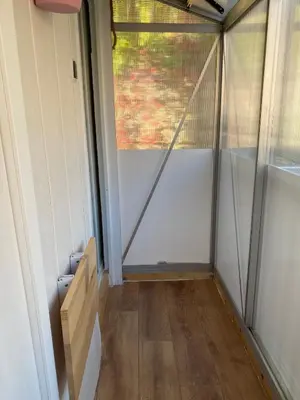 a room with a glass door and a wooden floor at OTA T2 proche rivières et plages, randonnées in Guaita