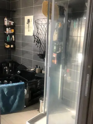 a kitchen with a stove and a glass door at T3 Baie de Calvi jardin panoramique vue mer in Calenzana