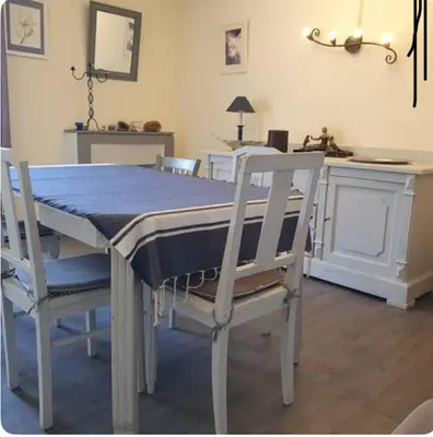a dining room with a table and two chairs at Appartement Caprunale Rivière & Maquis in Manso
