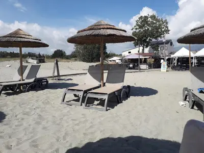 a group of chairs and umbrellas on a beach at Corse-San Giuliano-maison- 2 mn de la plage in San-Giuliano