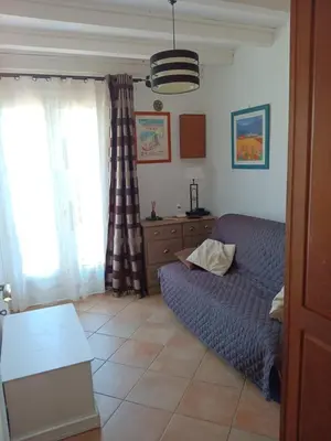 a living room with a couch and a table at Corse-San Giuliano-maison- 2 mn de la plage in San-Giuliano