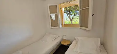 a small room with a couch and a window at T3 Dolce & Vita D5 avec Piscine et vue Montagnes in Propriano
