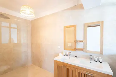 a bathroom with a sink and a shower at Villa avec piscine et vue mer à 230m de la plage in Zonza