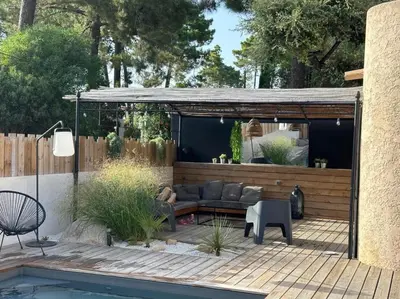 a patio with a couch and a table and a pool at Villa Saint-Cyprien Corse in Lecci