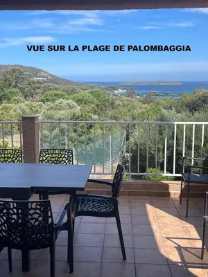 a table and chairs on a balcony with a view of the ocean at Résidence U LATONU in Porto-Vecchio