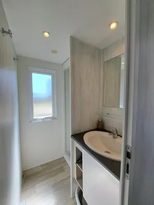 a bathroom with a sink and a window at chalet 3 au cœur du maquis in Bonifacio