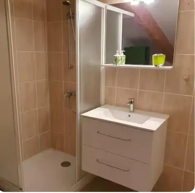 a bathroom with a white sink and a shower at Appartement Paglia Orba Rivière & maquis in Manso