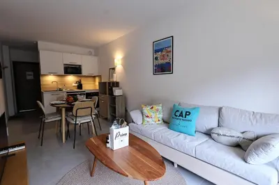 a living room with a couch and a table at U Speronu - Plage Privée & Piscine Chauffée in Pianottoli-Caldarello