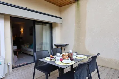 a table with plates of food on it on a patio at U Speronu - Plage Privée & Piscine Chauffée in Pianottoli-Caldarello
