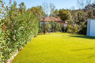 a garden with a gazebo in the background at Casa Cavu di Santa Lucia in Sainte-Lucie de Porto-Vecchio