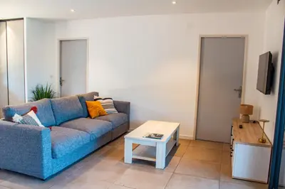 a living room with a blue couch and a coffee table at Casa Cavu di Santa Lucia in Sainte-Lucie de Porto-Vecchio