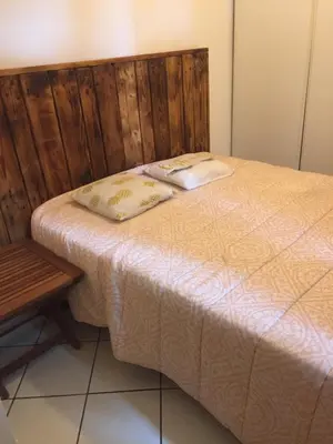 a bed with two pillows on it next to a table at Quadrale in Sotta