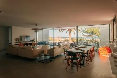 a living room with a couch and a table and chairs at Elegant Architect-Designed Home In Upper Corsica in Taglio-Isolaccio