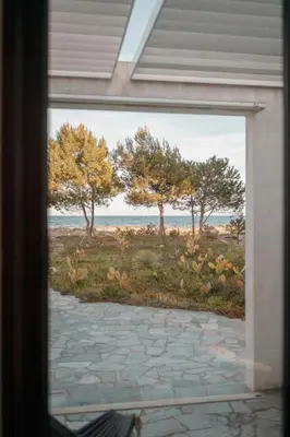 a painting of a view of a beach through a window at Elegant Architect-Designed Home In Upper Corsica in Taglio-Isolaccio