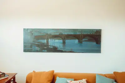 a painting of a bridge on a white wall at Elegant Designer Home By The Sea In Corsica in Taglio-Isolaccio
