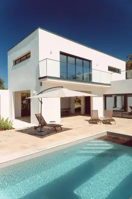 a villa with a swimming pool and a house at Elegant Designer Home By The Sea In Corsica in Taglio-Isolaccio