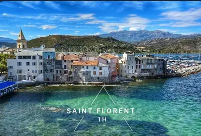 a group of buildings in the water next to a town at Amikad'o in San-Nicolao