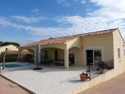 a house with a patio and a swimming pool at Villa CORSE in Solaro