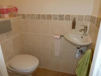 a bathroom with a toilet and a sink at Villa CORSE in Solaro