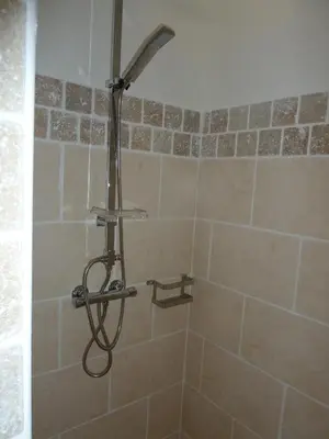 a shower with a shower head in a bathroom at Villa CORSE in Solaro