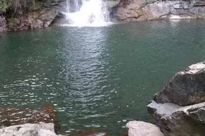 a waterfall in the middle of a pool of water at Villa en Corse sur la Côte Est in Santa-Maria-Poggio