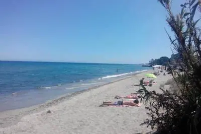 a group of people laying on a beach at Villa en Corse sur la Côte Est in Santa-Maria-Poggio