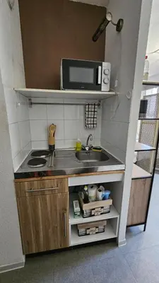 a small kitchen with a sink and a microwave at Studio Gare Corte in Corte
