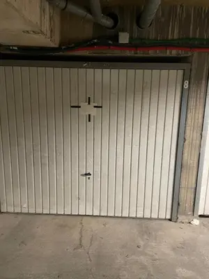 a metal garage door with a cross on it at CASA LOUNA 2 Pièces à 150 m de la plage et du centre vile in Sari Solenzara