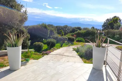 two large white vases on a balcony with a garden at Apartment 3 rooms with garden in Ajaccio in Ajaccio