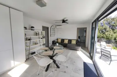 a living room with a table and chairs at Apartment 3 rooms with garden in Ajaccio in Ajaccio