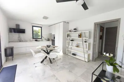 a kitchen and dining room with a table and chairs at Apartment 3 rooms with garden in Ajaccio in Ajaccio